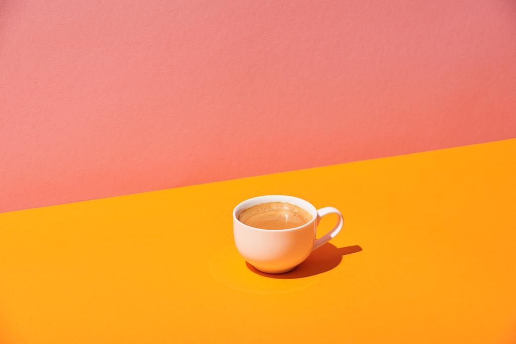 coffee cup on yellow surface and pink background - Photo, Image