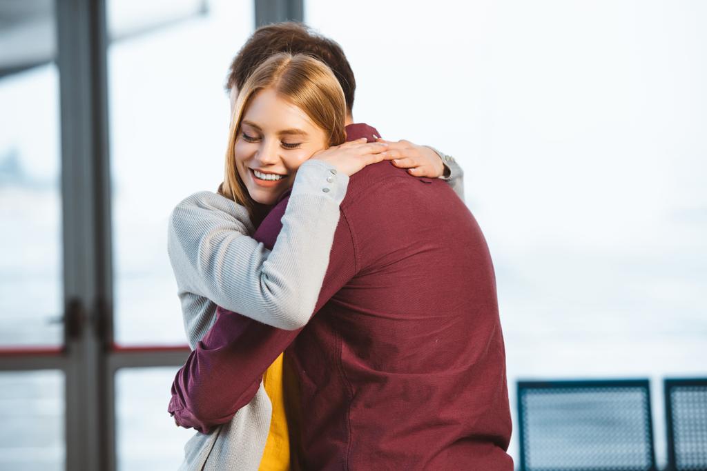 attractive woman smiling with closed eyes while hugging boyfriend - Photo, Image