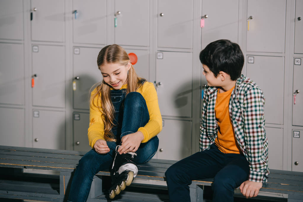 Children talking while putting on roller skates - Photo, Image