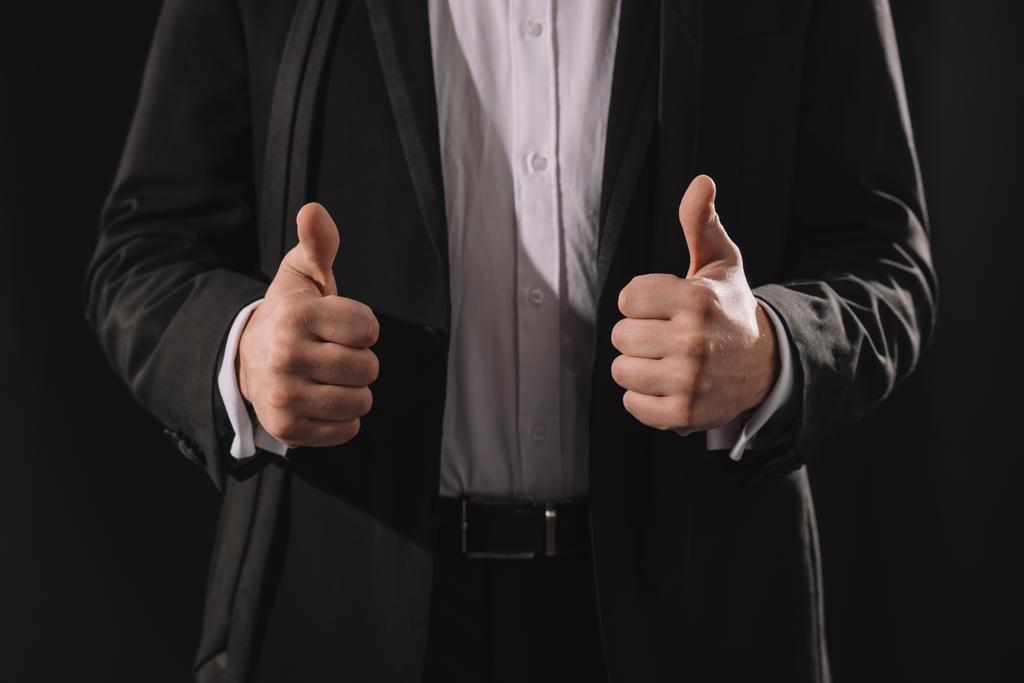 man in formal wear showing thumbs up isolated on black - Photo, Image