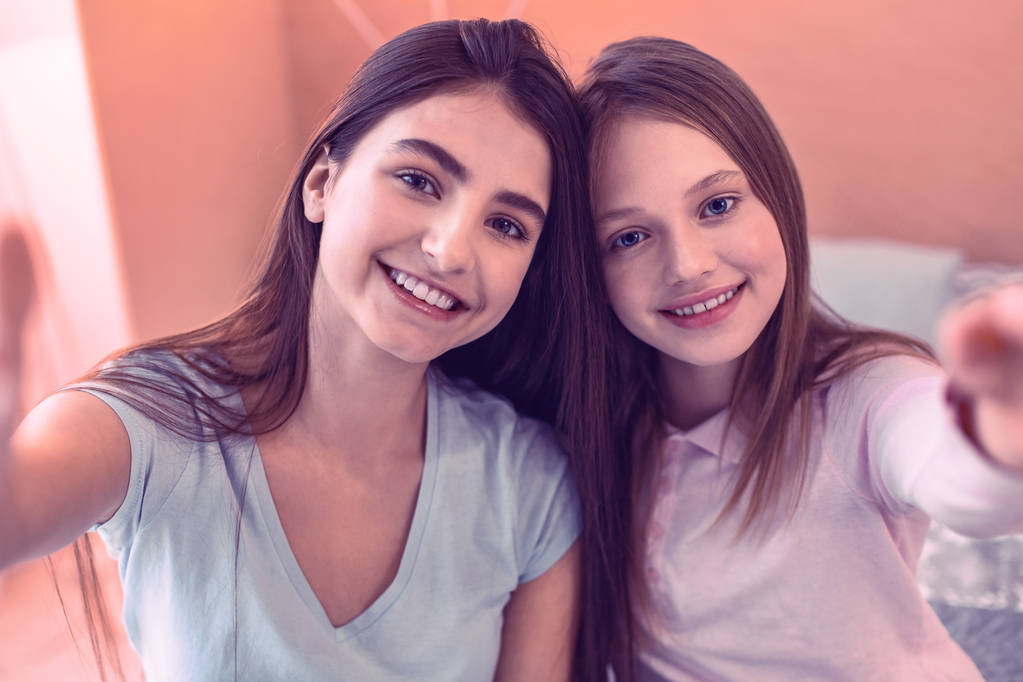 Pleasant smiling teenagers posing for photo together - Photo, Image