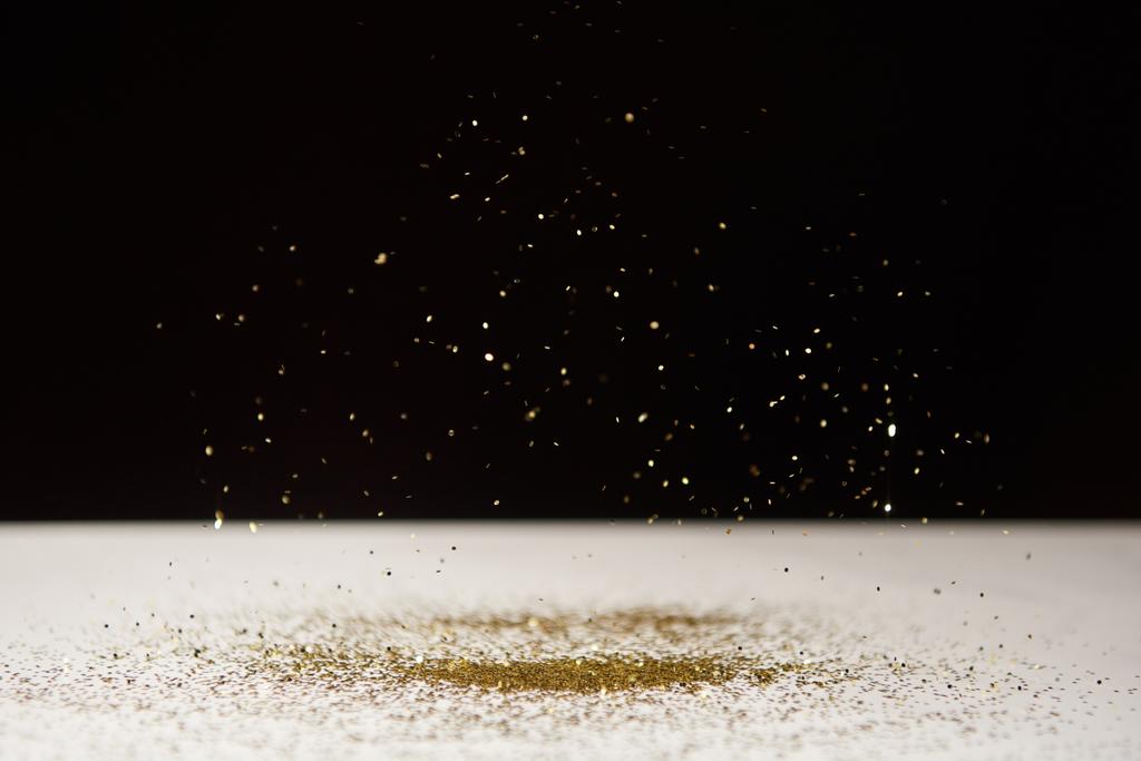 selective focus of white table with bright sparkles isolated on black  - Photo, Image