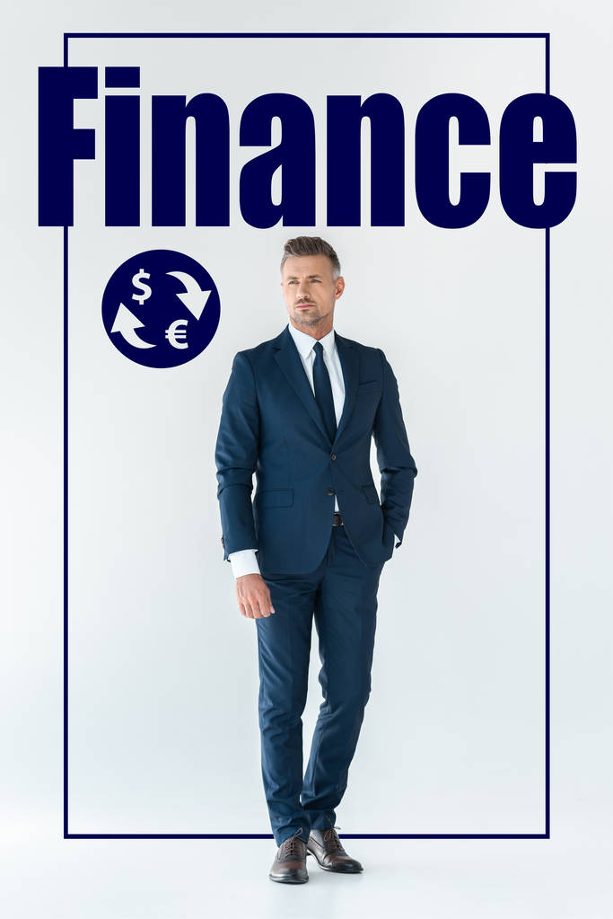 przystojny biznesmen w Niebieski garnitur, stojąc i patrząc od biały na białym tle na ikonami finansów  - Zdjęcie, obraz