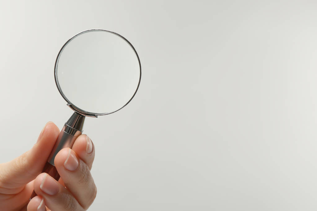 Woman holding magnifying glass on white background, closeup. Space for text - Photo, Image