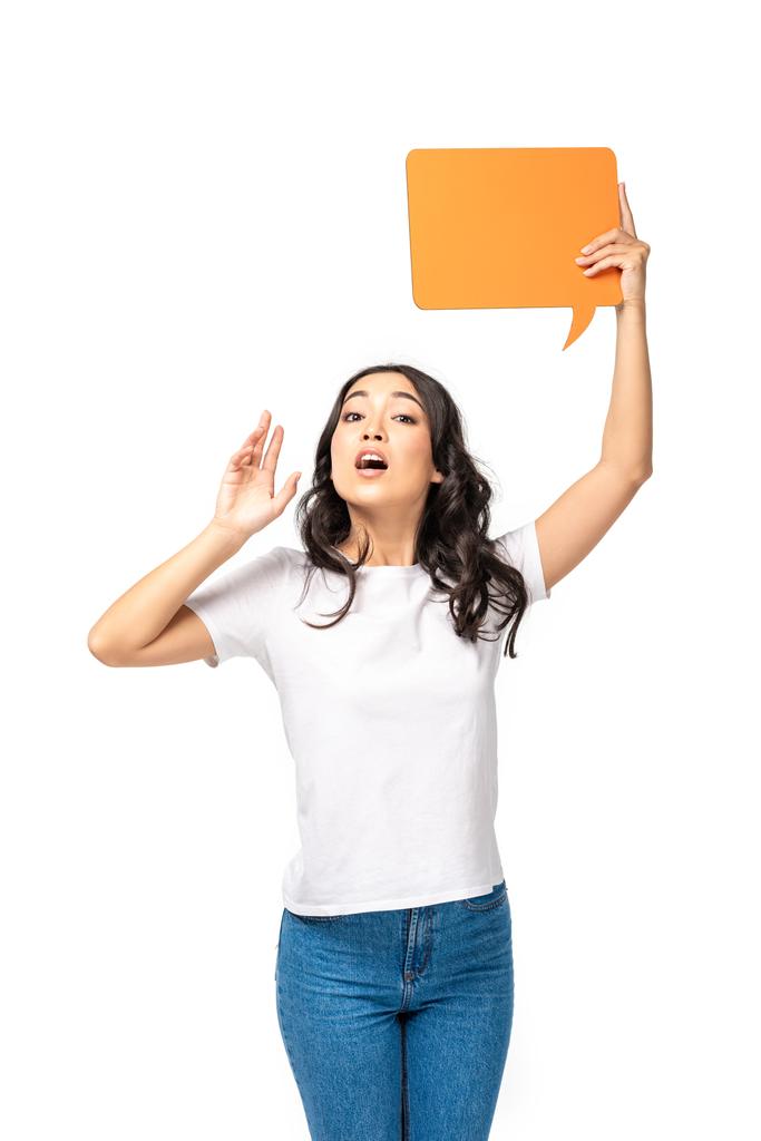 Screaming asian woman in white t-shirt and blue jeans holding speech bubble isolated on white - Photo, Image