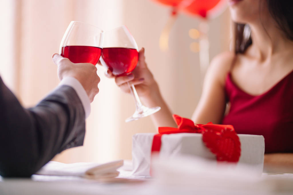 Valentine's Day concept. Happy couple in love with. A young loving couple celebrating Valentine's Day in the restaurant. Lovers give each other gifts. Romance restaurant for Valentine's Day- concept. - Photo, Image