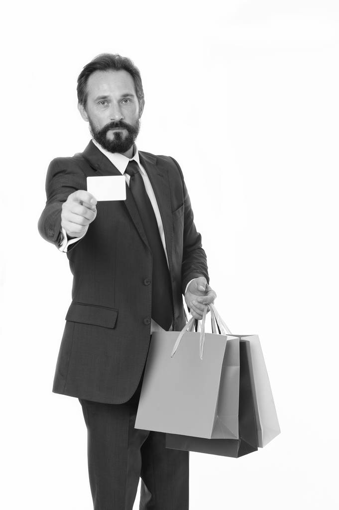 Ask deliver your purchases. Businessman formal suit holds bunch paper bags while show business card. Man bearded businessman use delivery service. Businessman hold plastic blank card copy space - Photo, Image