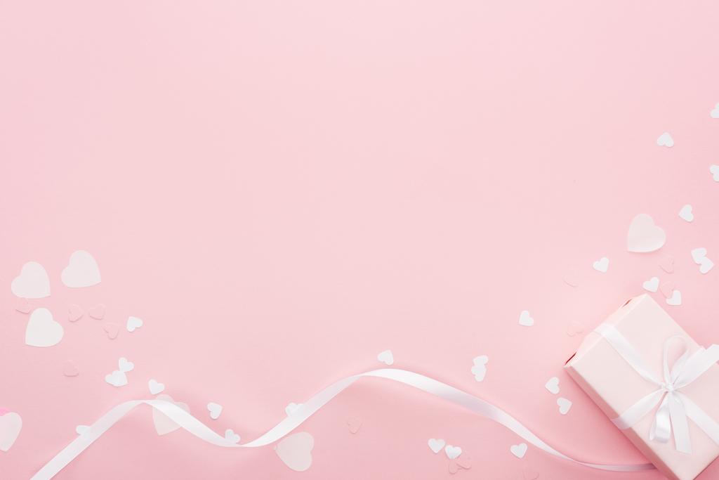фон з подарунковою коробкою та паперовими серцями ізольовані на рожевому
 - Фото, зображення