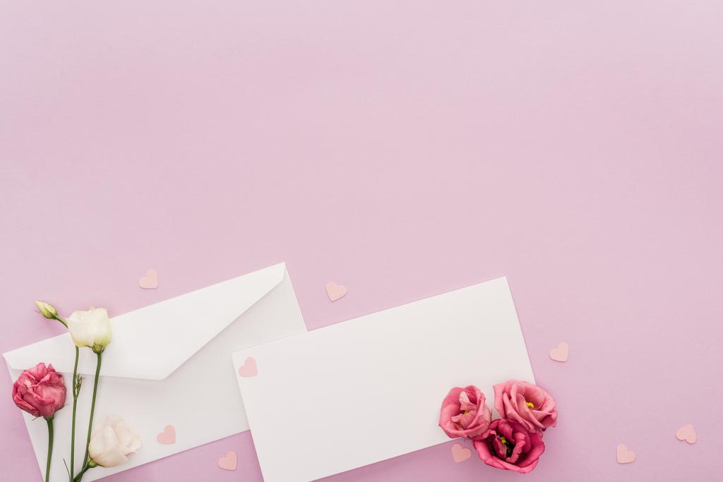 top view of empty card, paper hearts and envelope isolated on pink - Photo, Image