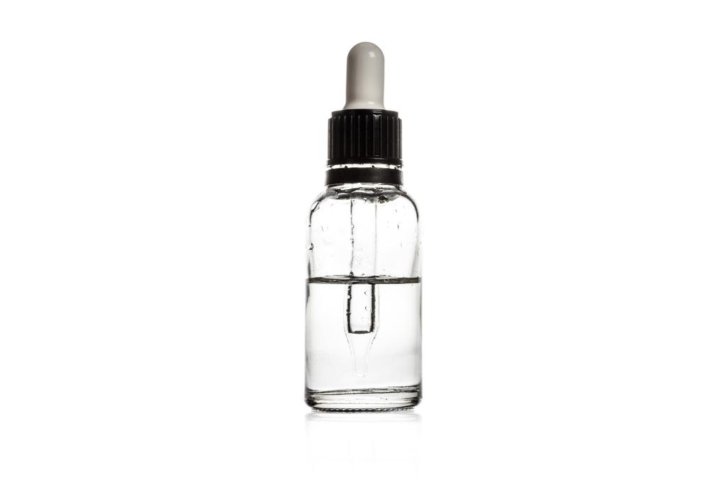 Studio shot of serum in glass bottle with dropper isolated on white - Photo, Image