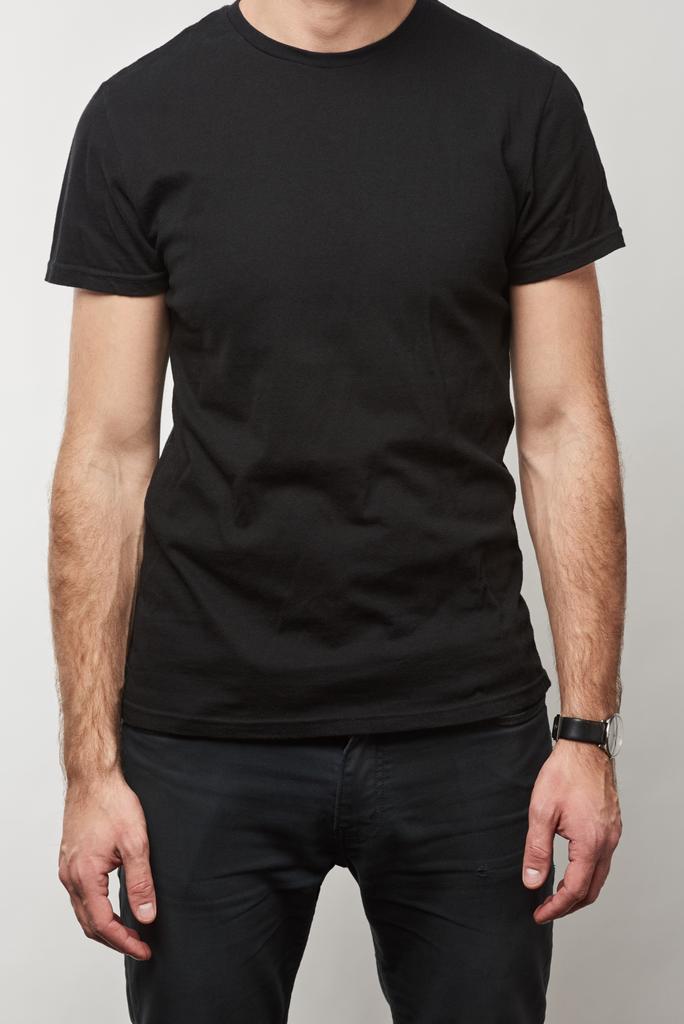 częściowy widok człowieka w czarny t-shirt z kopia miejsce na białym tle na szary  - Zdjęcie, obraz