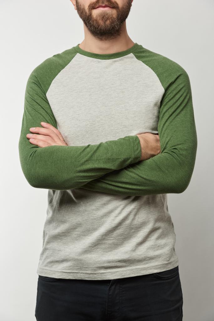 gedeeltelijke weergave van man met armen gekruist in honkbal shirt met raglan mouwen met kopie ruimte geïsoleerd op grijs - Foto, afbeelding