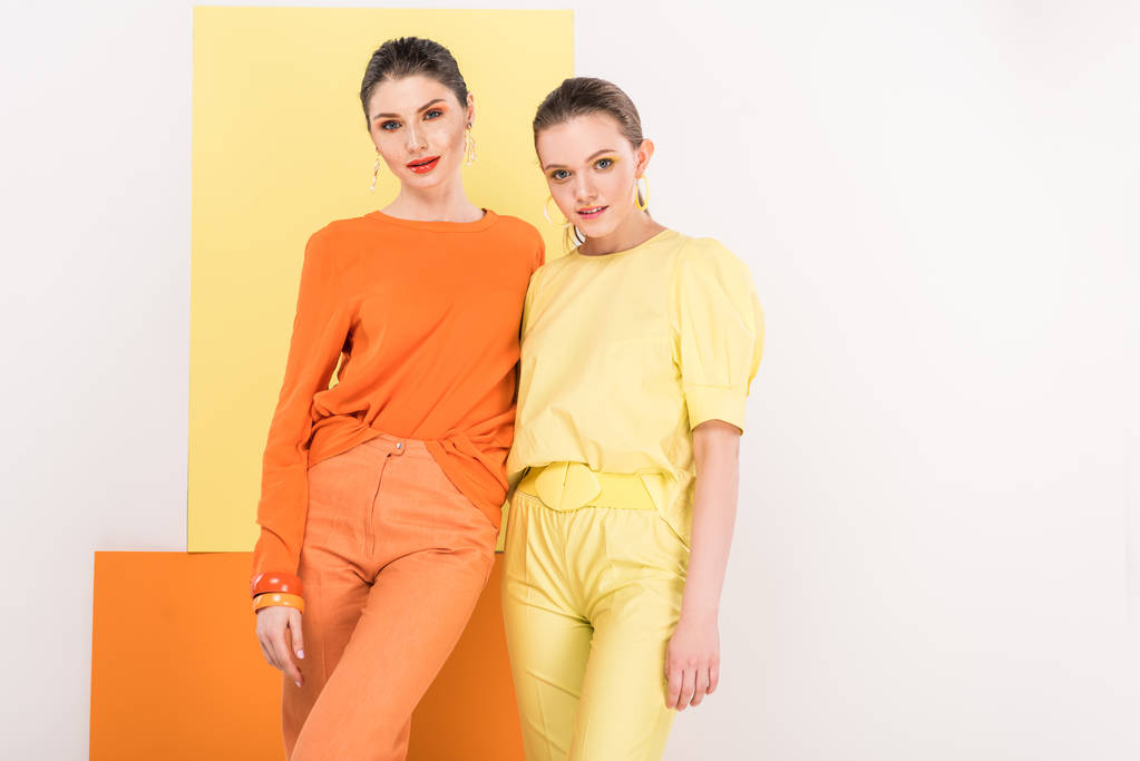 beautiful fashionable girls posing with turmeric and limelight on background - Photo, Image