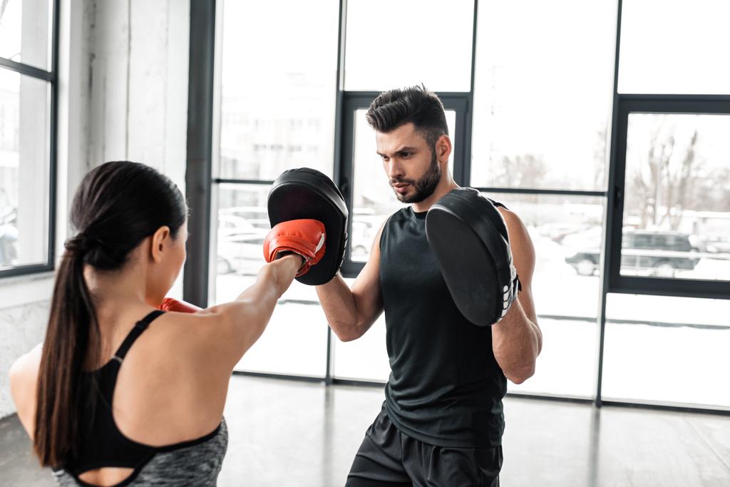 young athletic couple boxing and training together in gym - Photo, Image