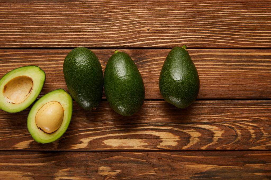 top view of avocados on wooden background - Photo, Image