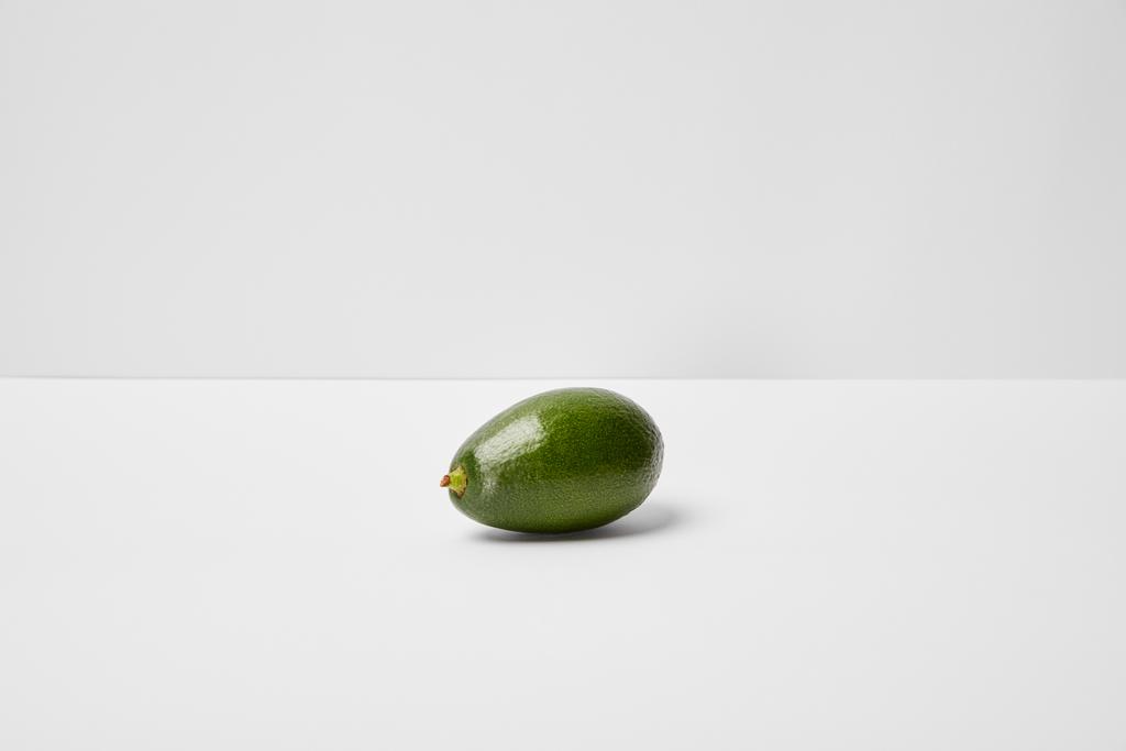 selective focus of whole avocado on grey background - Photo, Image