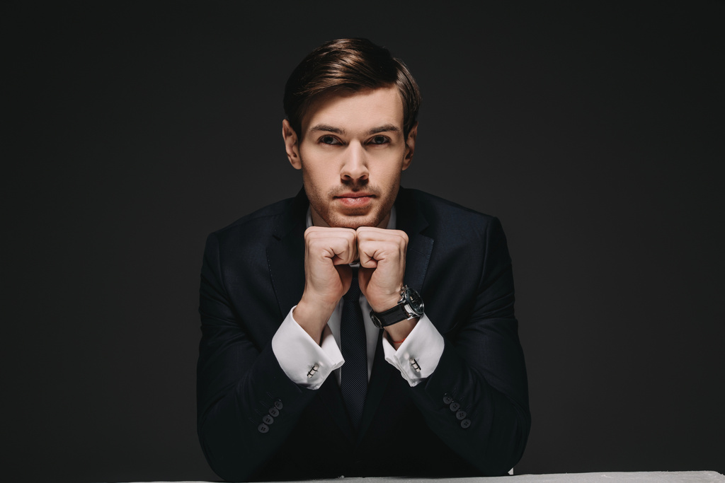 handsome businessman in suit looking at camera isolated on black - Photo, Image