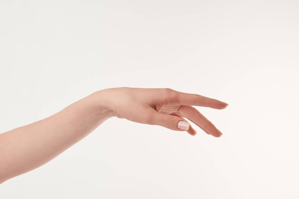 Gedeeltelijke weergave van verzorgde vrouw hand op witte ondergrond - Foto, afbeelding