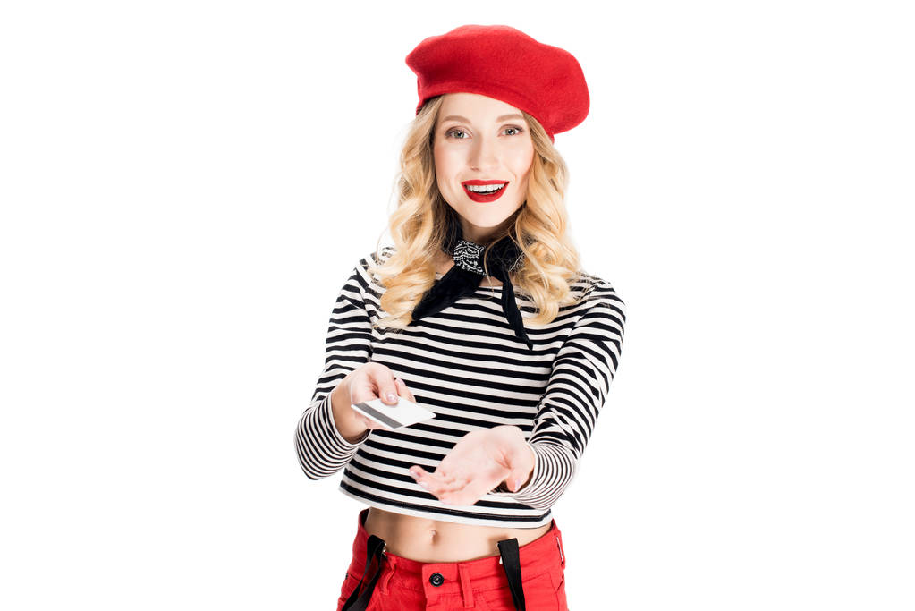 attractive woman in red beret smiling while holding credit card isolated on white  - Photo, Image
