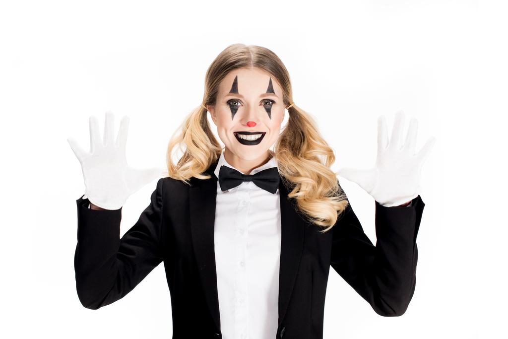 aufgeregter weiblicher Clown lächelt, während er weiße Handschuhe auf weißem Grund zeigt  - Foto, Bild