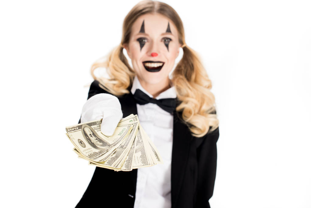 smiling clown with blonde hair holding dollar banknotes isolated on white  - Photo, Image