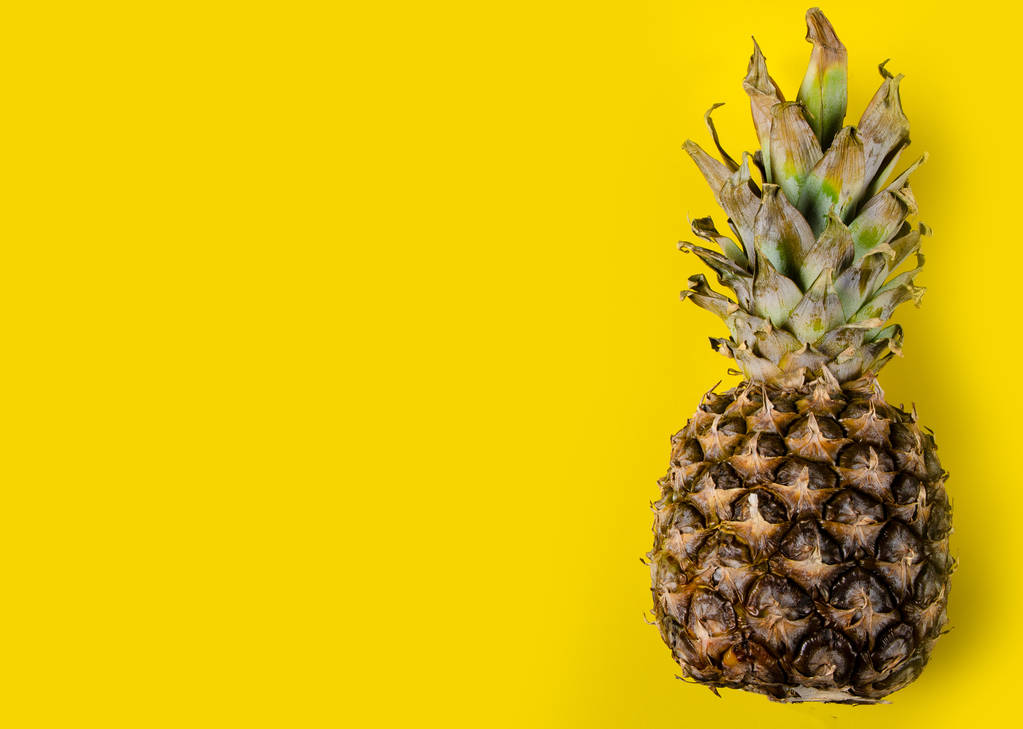 Pineapple fruit on yellow background, top view - Photo, Image