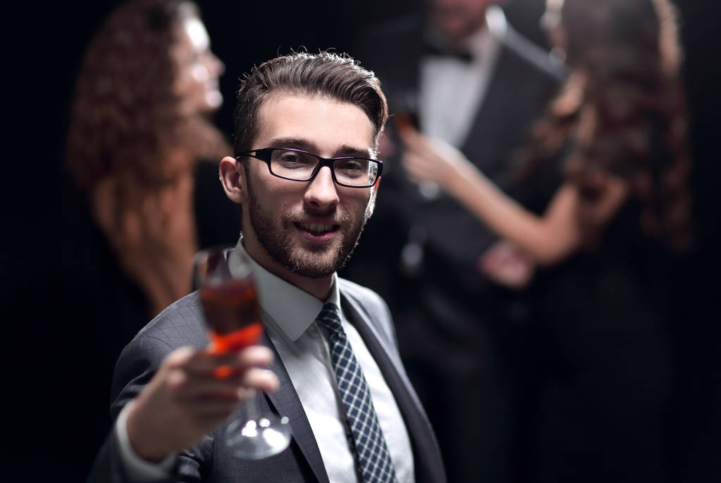 elegant man raising a glass of champagne - Photo, Image