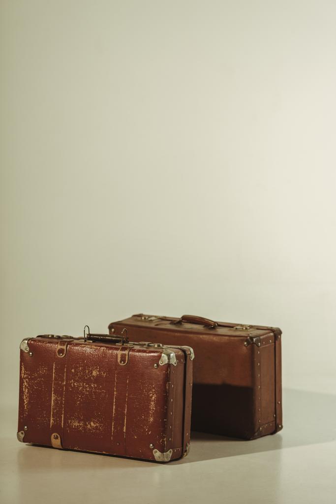 vintage brown leather travel bags on beige with copy space - Photo, Image