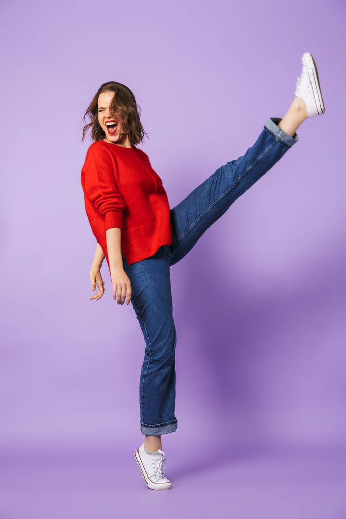 Image of an excited beautiful young woman posing isolated over purple background wall. - Photo, Image