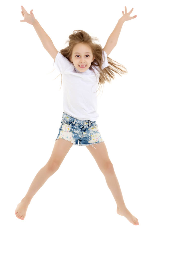 A little girl in a pure white t-shirt is jumping. The concept of - Photo, Image