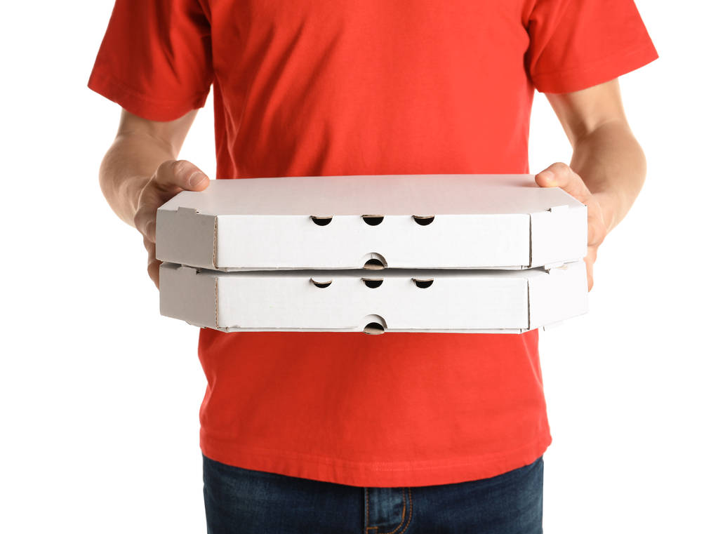 Молодой человек с коробками пиццы на белом фоне. Доставка продуктов питания
 - Фото, изображение