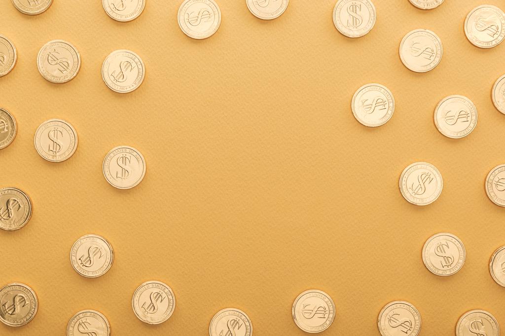 κάτοψη λαμπερά χρυσά νομίσματα με σημεία δολάριο που απομονώνονται σε πορτοκαλί με αντίγραφο χώρος, st patrick ημέρα έννοια - Φωτογραφία, εικόνα