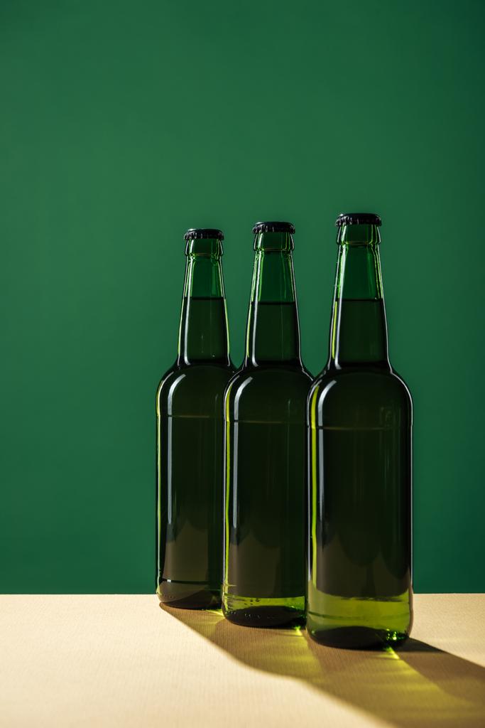 beer bottles with shadows isolated on green, st patrick day concept - Photo, Image