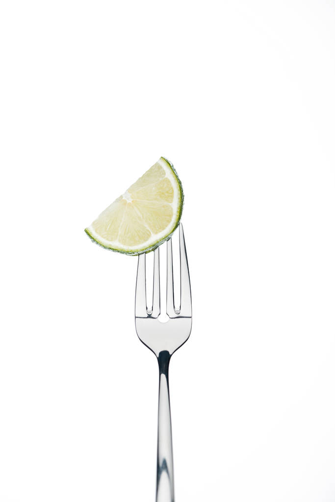 media rebanada de limón jugoso fresco y maduro en un tenedor aislado en blanco
 - Foto, Imagen
