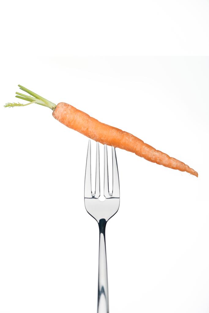 whole ripe fresh carrot on fork isolated on whiteisolated on white - Photo, Image