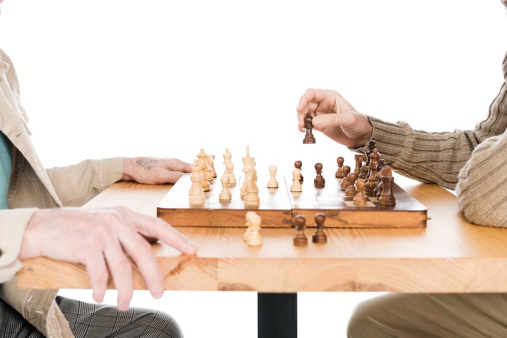 cropped view of retired men playing chess isolated on white - Photo, Image