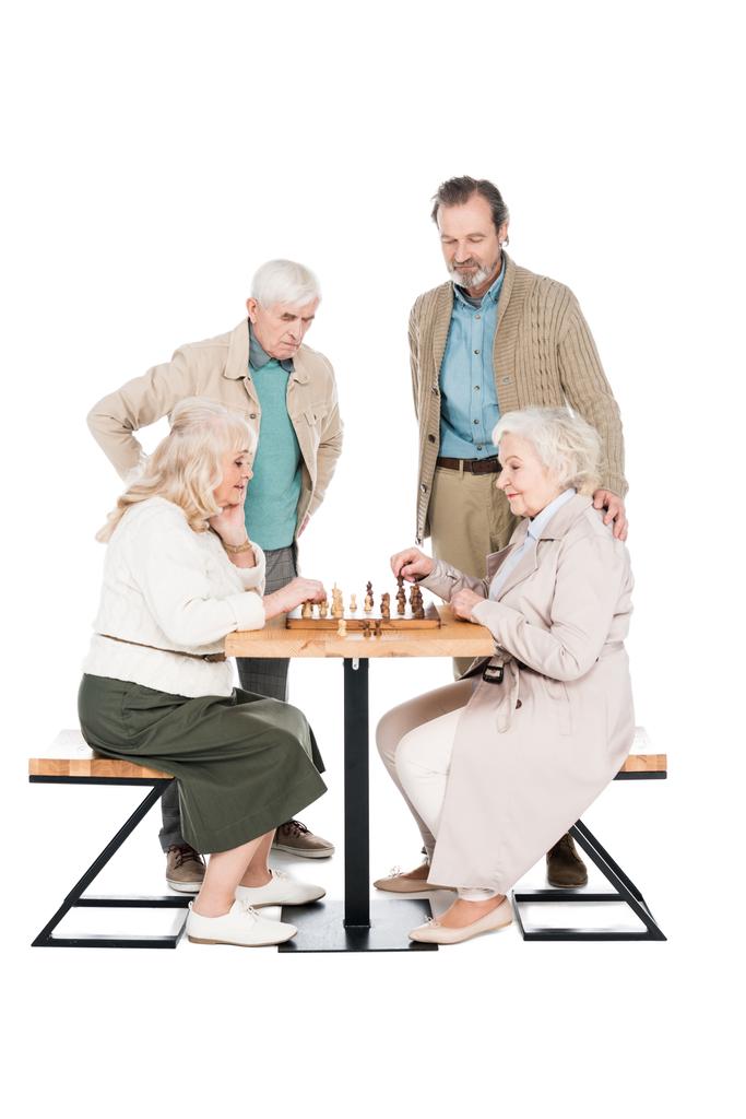 Happy starší ženy hrají šachy poblíž důchodu muži izolované na bílém - Fotografie, Obrázek