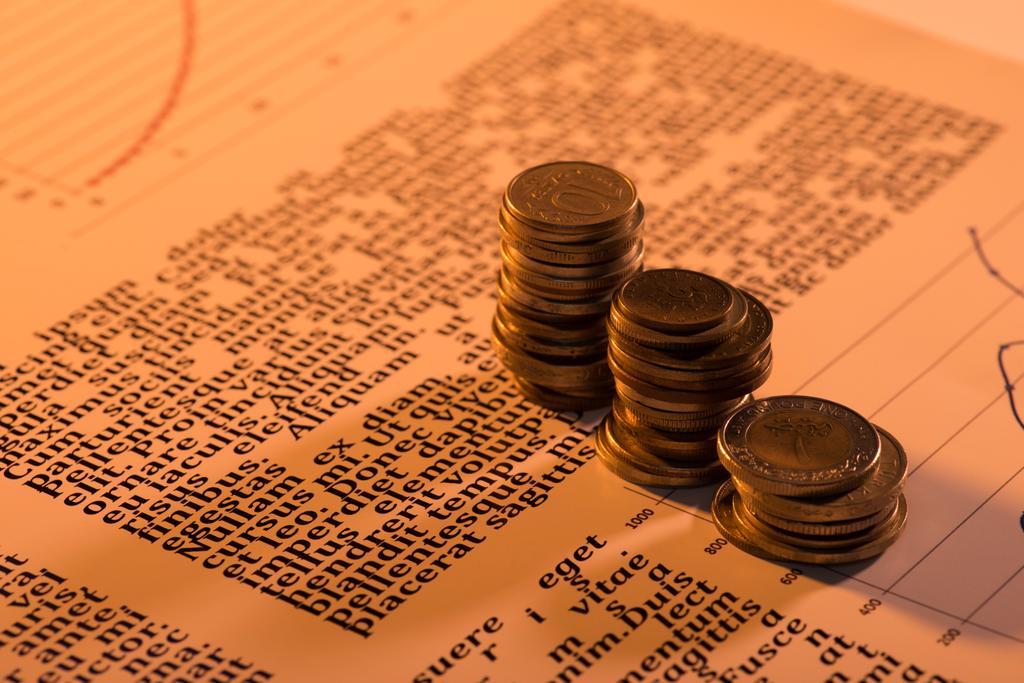 selective focus of coins stacks on text document with blurred background - Photo, Image