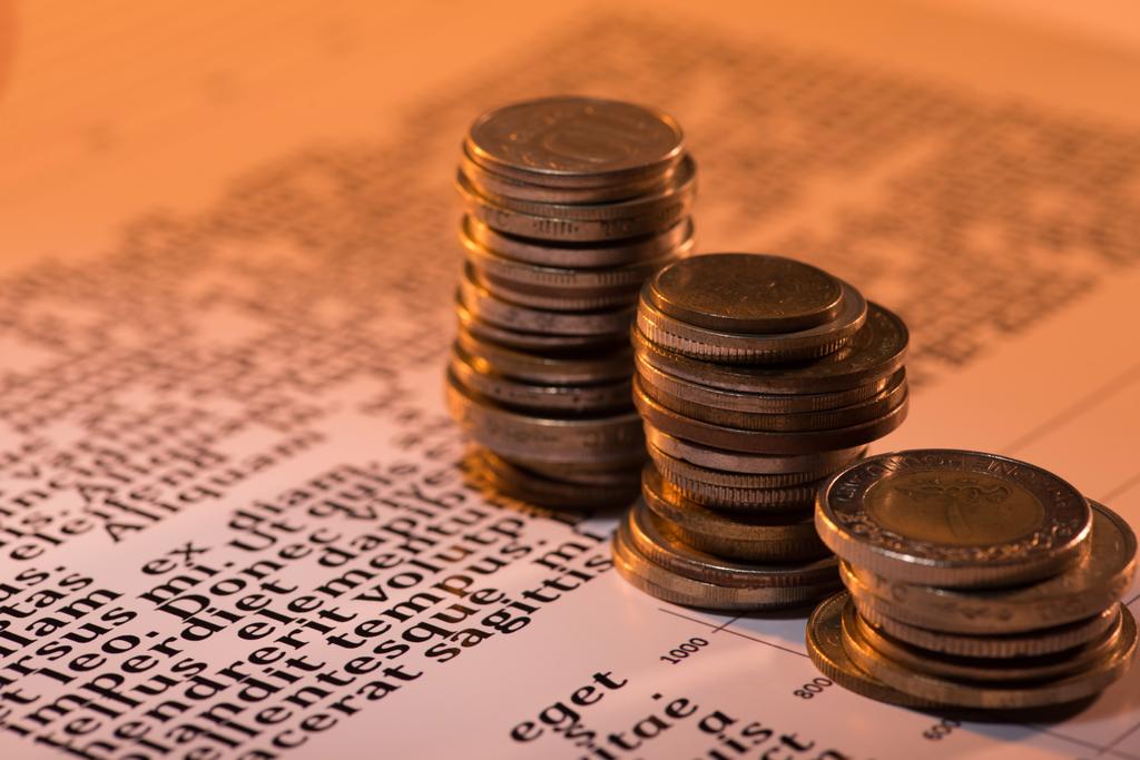 selective focus of coins stacks on business blurred document with text - Photo, Image