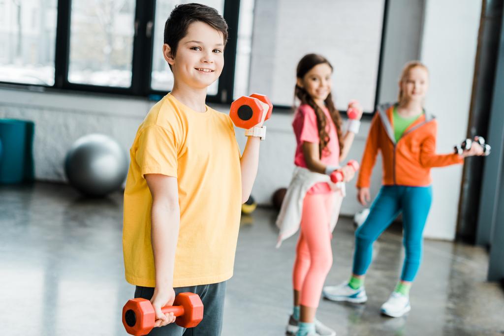 Grupo de niños entrenando con pesas en el gimnasio
 - Foto, imagen