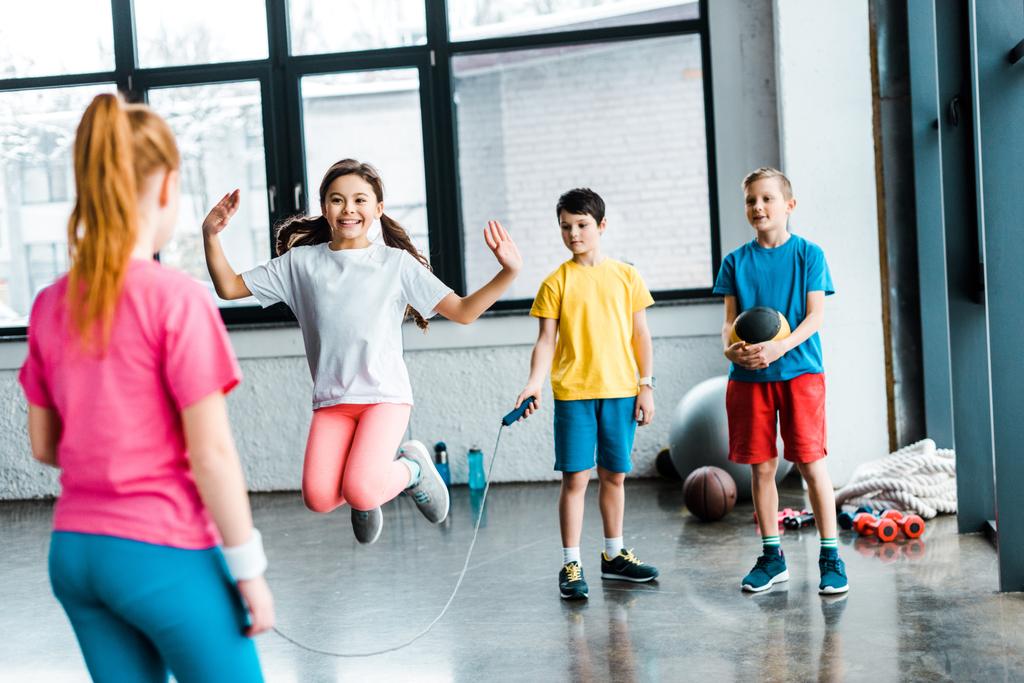 Preteen kids jumping with skipping rope in gym - Photo, Image