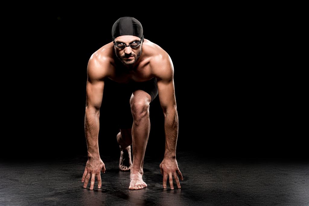handsome swimmer standing in start position on black background  - Photo, Image