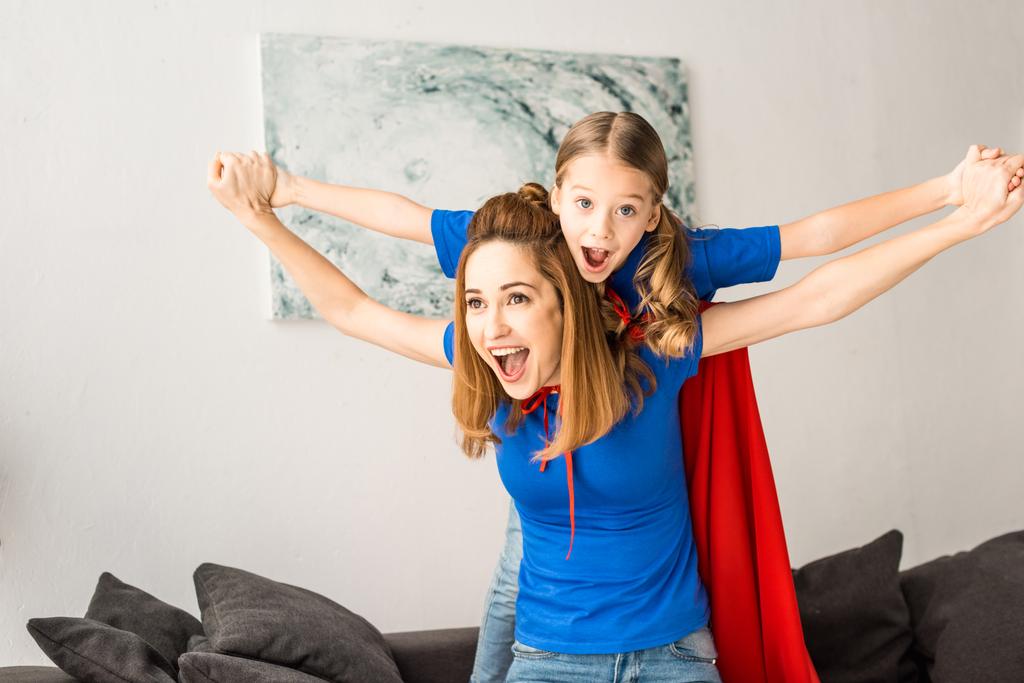 Cheerful mother and daughter playing at home - Photo, Image