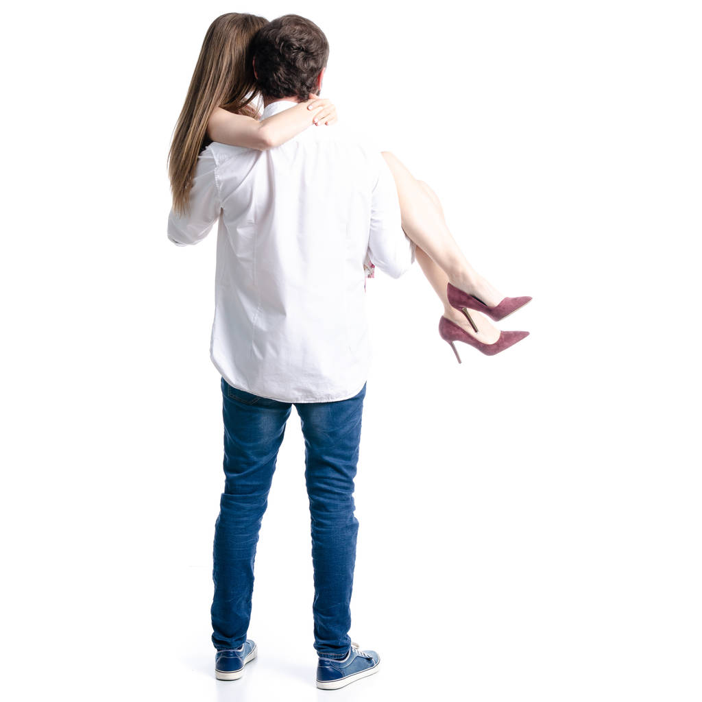 Człowiek posiada Kobieta w jego ramiona para miłość na białym tle izolacji, widok z tyłu - Zdjęcie, obraz