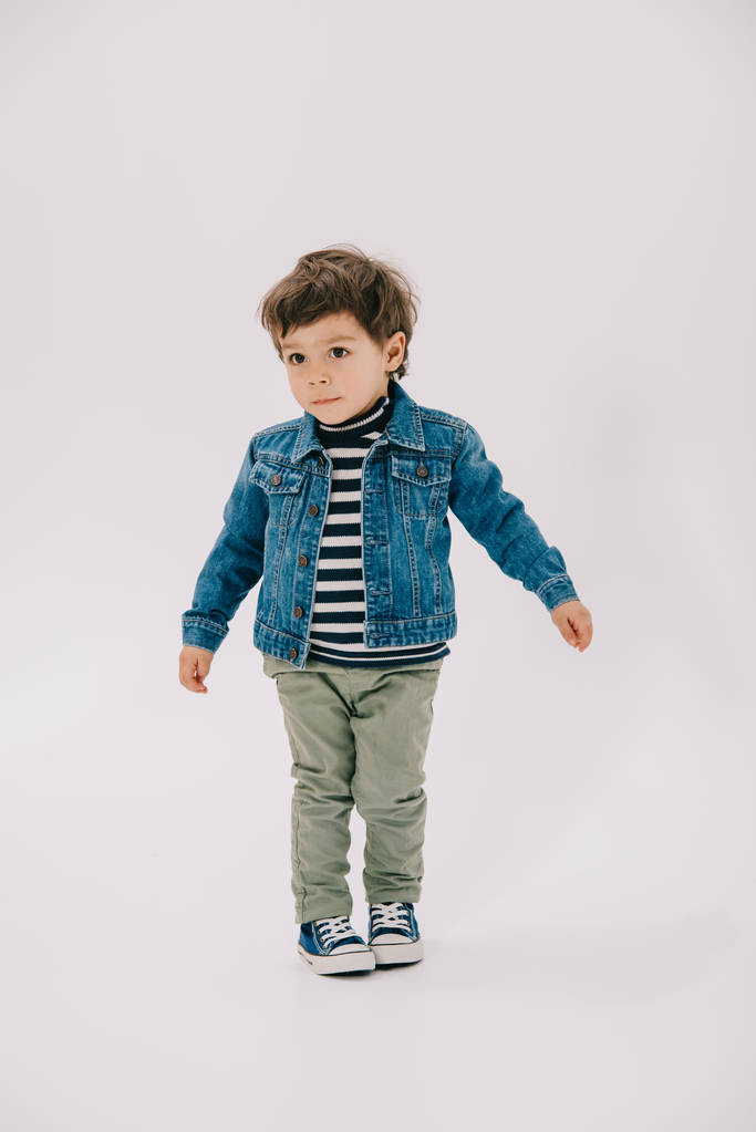 adorable little boy in blue jacket and green jeans isolated on white - Photo, Image