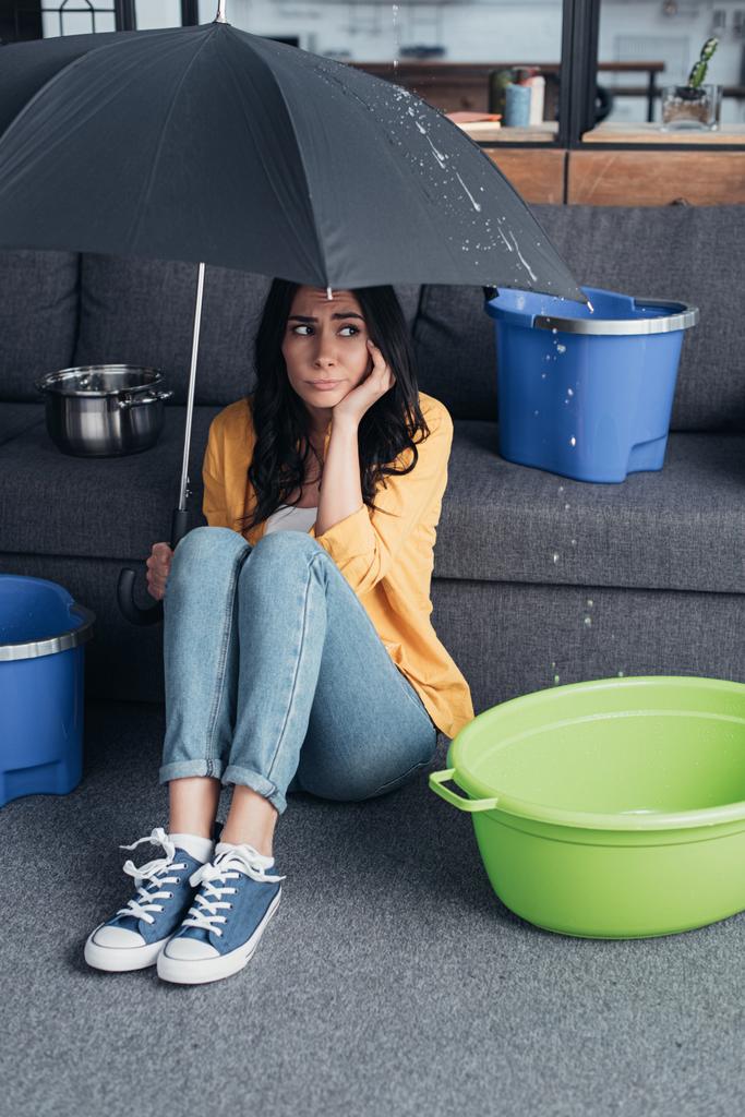 Smutná dívka v džíny sedí na podlaze s deštníkem - Fotografie, Obrázek
