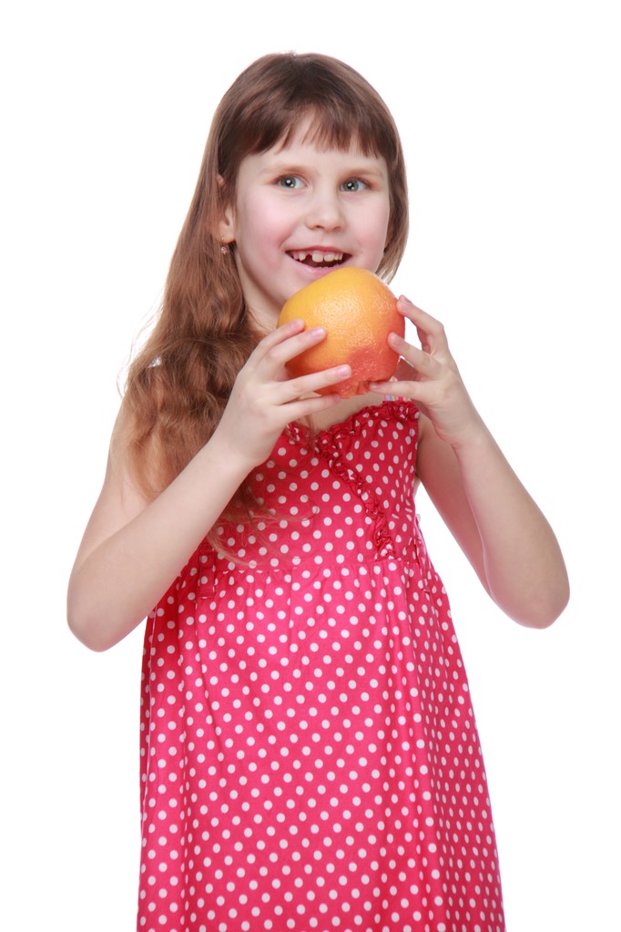 charmante kind eten grapefruit - Foto, afbeelding
