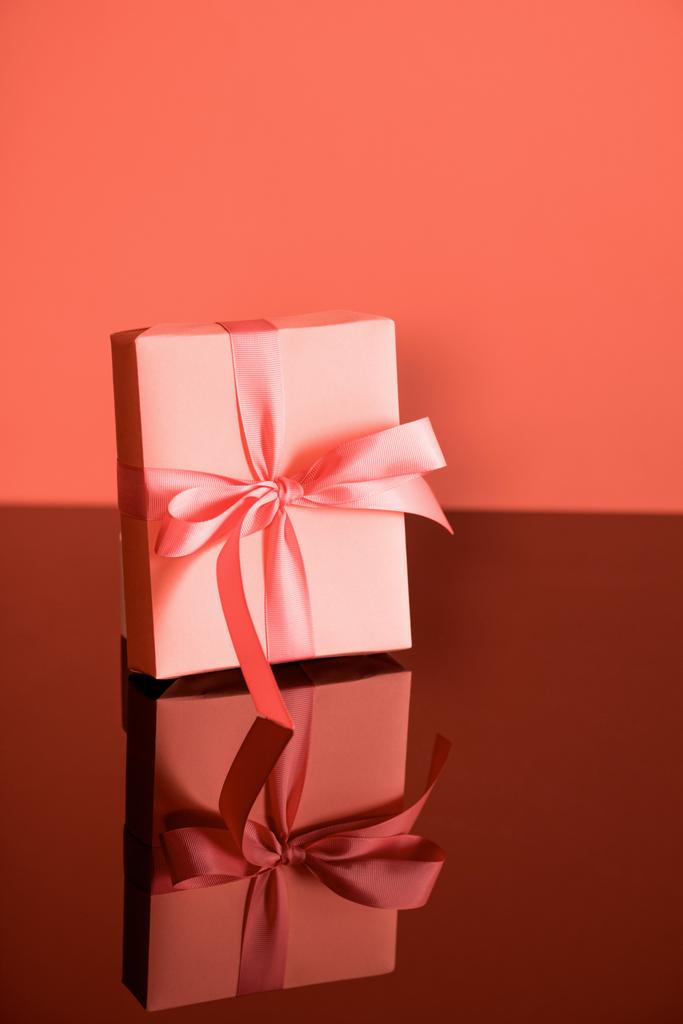 birthday gift box in living coral color. Pantone color of the year 2019 concept  - Photo, Image