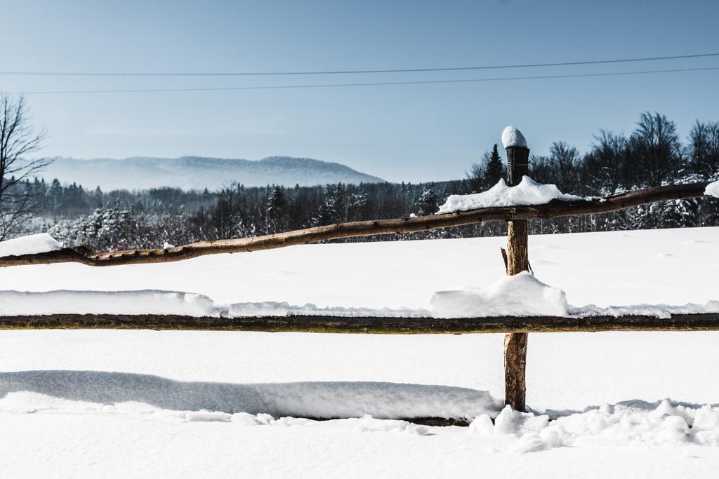 wooden fence covered with snow in carpathian mountains - Photo, Image