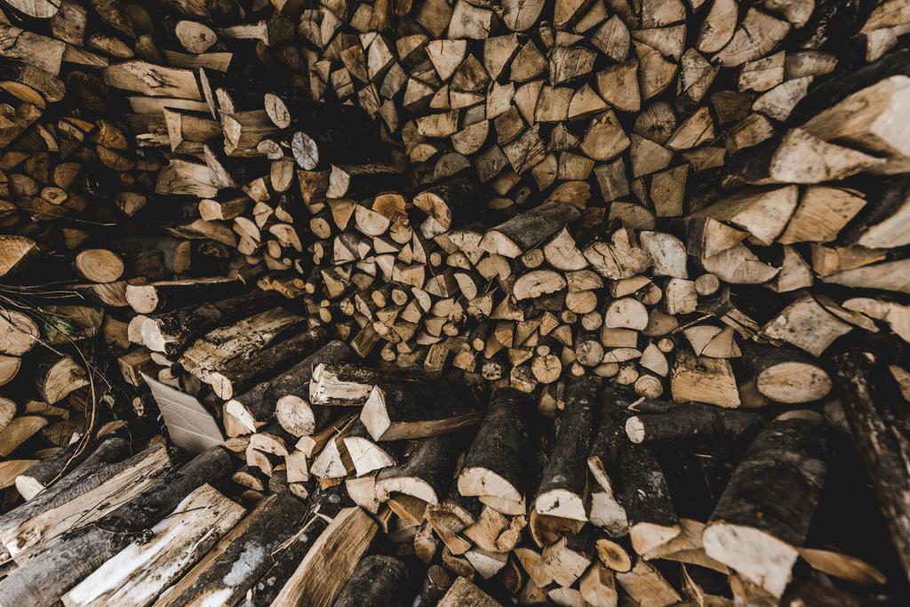 pile of brown stacked textured cut firewood - Photo, Image